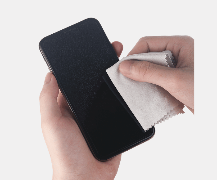 Image of hands cleaning mobile phone screen with microfiber